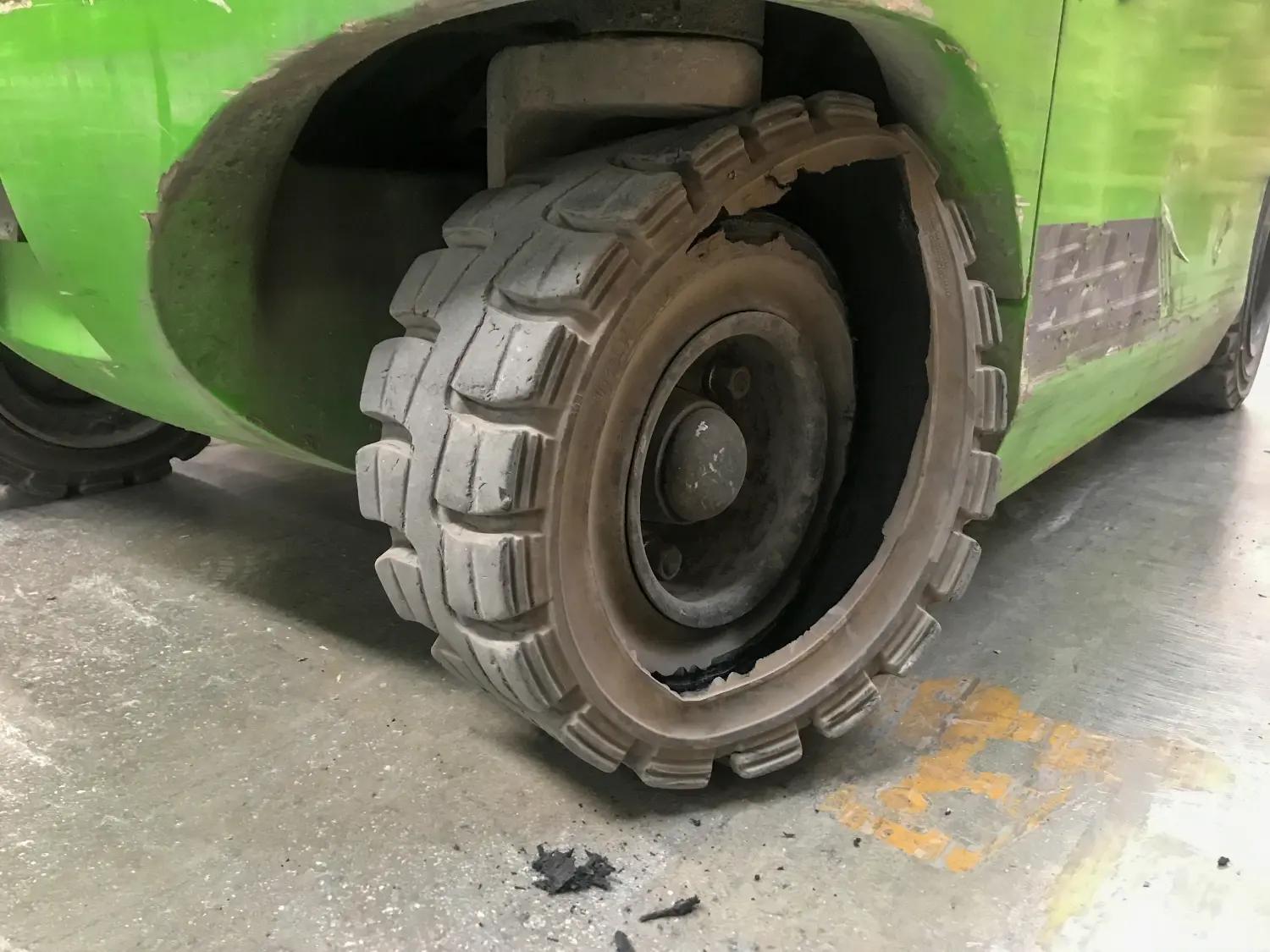 Close up photo of broken solid tire of a forklift. 